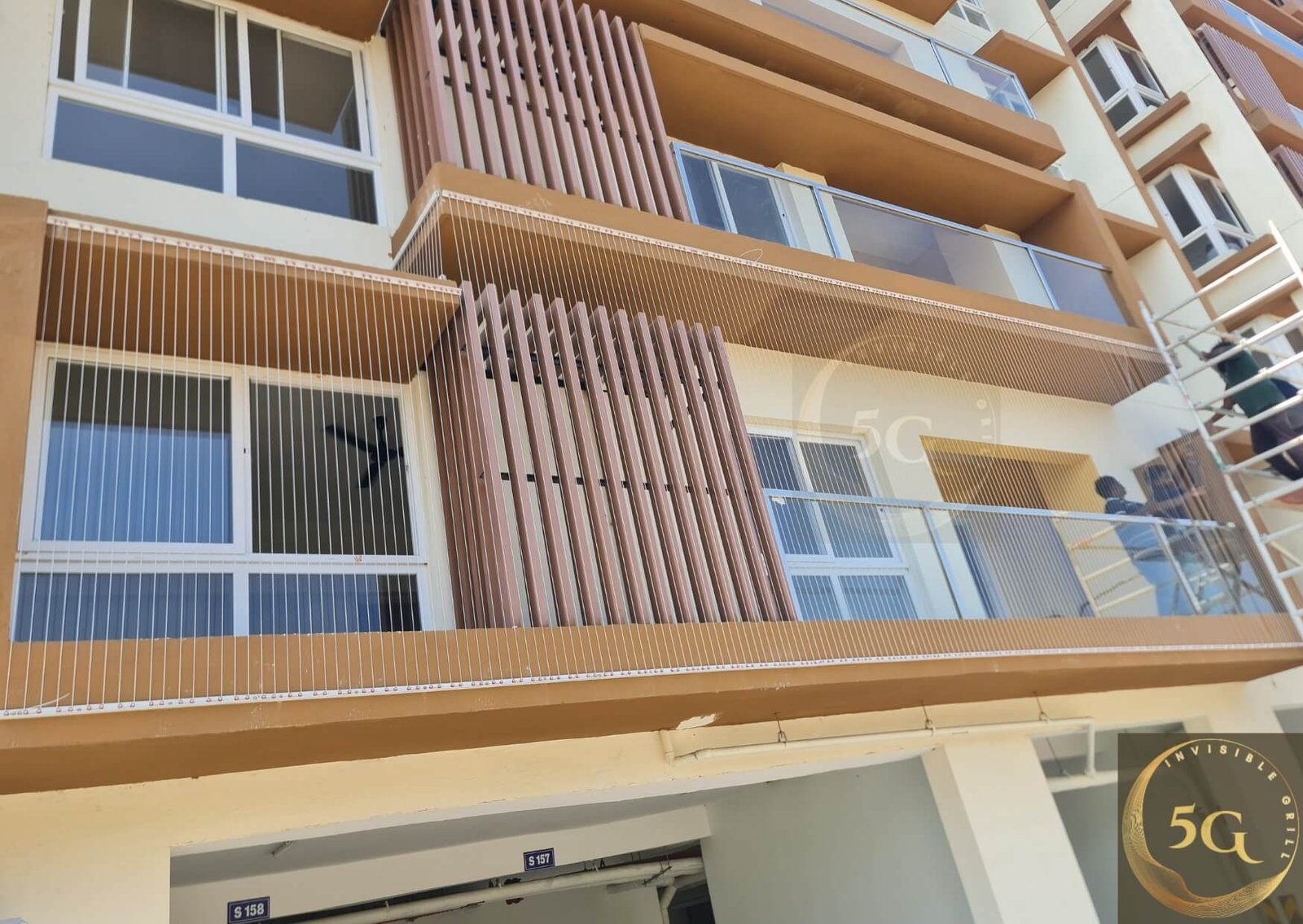 Multiple apartment balconies with installed steel invisible grille systems maintaining modern building facade aesthetic