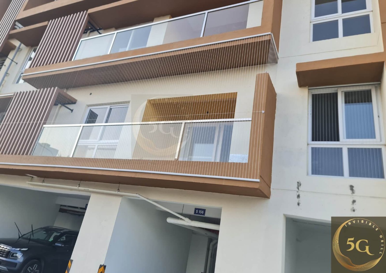 Modern apartment balcony with transparent invisible safety grille providing security without blocking views